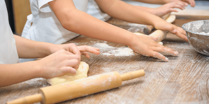 Children rolling dough inside