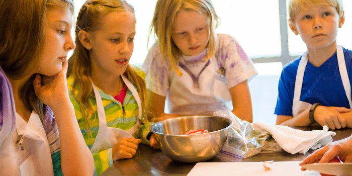 Girl cooking in cookery class for children